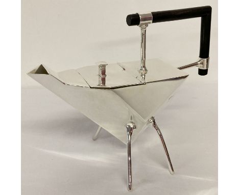 A silver plated Christopher Dresser style teapot of Art Deco design. Abstract triangular form, raised on 4 tubular legs and w