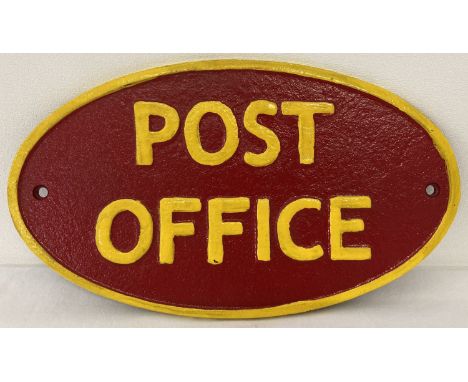 A painted cast iron oval shaped Post Office wall plaque. In red and yellow and with fixing holes. Approx. 14cm x 25cm.
