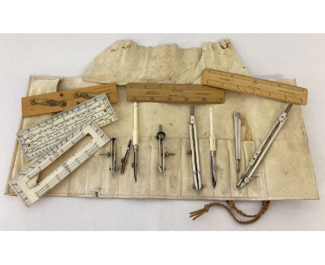 A draughtsman leather roll with vintage instruments. To include rules, measures, compasses and dividers. Some with war depart