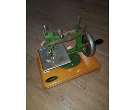 A VINTAGE GRAIN MINIATURE SEWING MACHINE