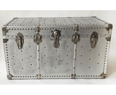 TRAVELLING TRUNK, studded aluminium with rising lid and carrying handles, 101cm x 52cm x 53cm H. 