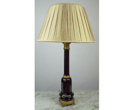 LAMP, Continental black glass with detailed engraved gilt metal mounts, on round base with paw feet, pleated silk shade 90cm 