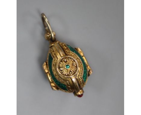 A gilt white metal and enamel egg shaped triptych charm, opening to reveal The Holy Trinity?, 27mm.