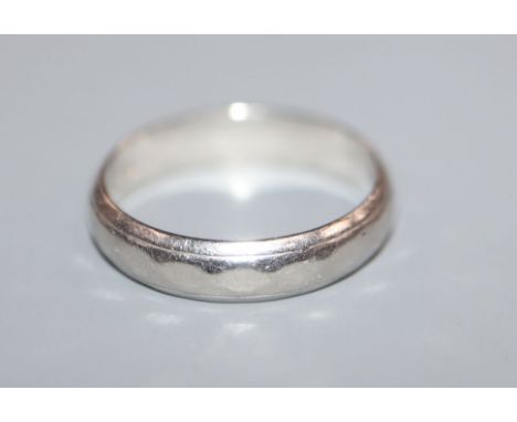 A white metal band stamped 'platinum', size K/L.