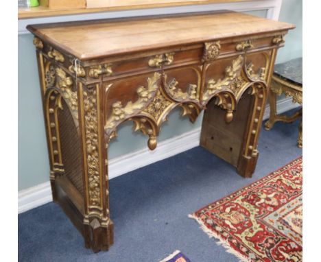 A Gothic revival carved parcel gilt console table W.130cm