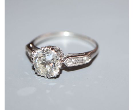 A mid 20th century white metal and single stone diamond ring, with diamond set shoulders, the old cut stone measuring approxi