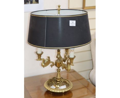 A brass lamp, with black and gold shade