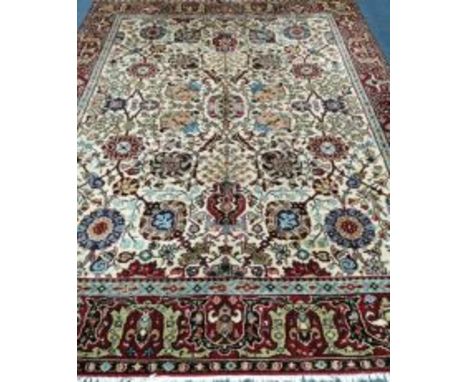 A Turkish ivory ground carpet 306 x 234cm