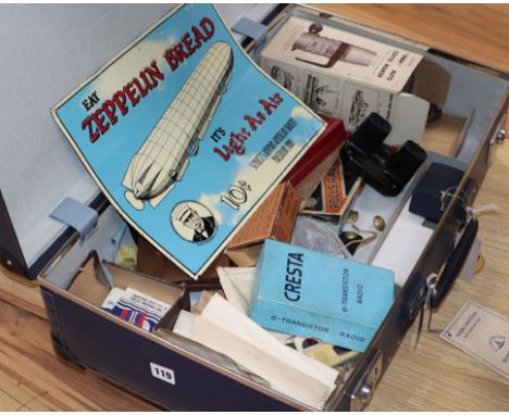 A vintage globetrotter case containing assorted ephemera to include glamour photo booklets, enamel sign etc.