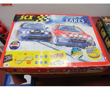 A SCX 1:32 Scale Racing System, 1000 lakes edition with snow effect, track, Citroen and Subaru present, playworn.