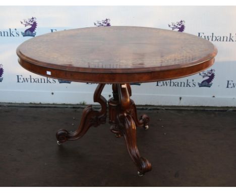 Victorian walnut and marquetry inlaid breakfast table, the top decorated with a ring of foliage, on openwork pillar, with scr