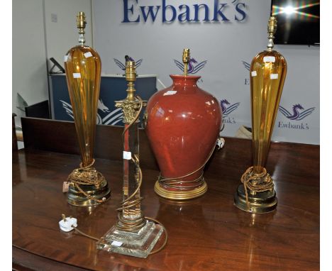 Pair of amber glass and brass lamps, 20th Century, 70cm high, together with a glass lamp with Corinthian column capital, 54cm