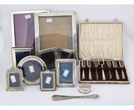 Six various silver photograph frames, the largest 23.5cm x 18.5cm, serviette ring, two other white metal photograph frames, c