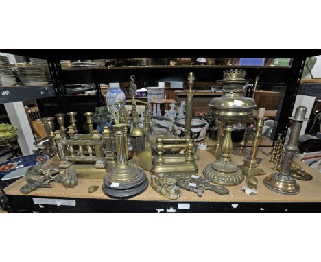 A large quantity of brass and copperwares including Kettles, Preserving pans, Fire Dogs, Candlesticks, Table lamp base, Oil L