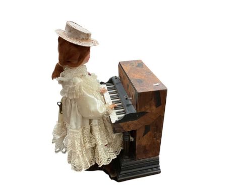 A rare antique French automaton music box, in the form of a woman playing the piano, complete with key and mechanism but not 