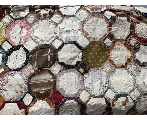 Early 19th century English paper pieceing patchwork quilt in hexagon and diamond design, paper templates remain in place but 