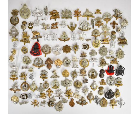 Large collection of approximately 100 British Army cap badges including Middlesex Regiment, Dorsetshire Regiment, Northampton