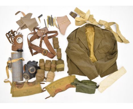 Military equipment including French respirator / gas mask in tin, Sam Browne belt, battle dress blouse, puttees, etc