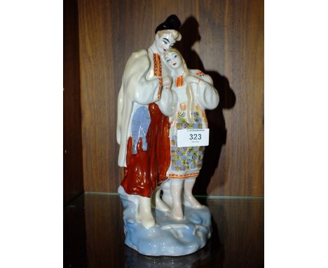 A RUSSIAN CERAMIC FIGURE OF A MAN AND WOMAN, H 27 CM