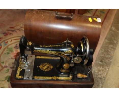 A CASED VINTAGE SINGER EA545988 SEWING MACHINE