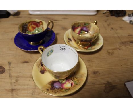THREE AYNSLEY ORCHARD GOLD CUPS AND SAUCERS, TWO WITH FRUIT PATTERN INTERIORS