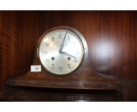 A VINTAGE OAK CASED NAPOLEON HAT MANTEL CLOCK