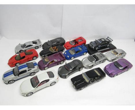 A collection of unboxed 1:18 scale diecast model sports cars to include Mattel Hot Wheels TVR speed 12 and Enzo Ferrari, Bbur