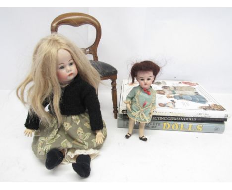 A small early 20th Century Heubach bisque head doll with fixed glass eyes, painted features and open mouth, impressed horshoe