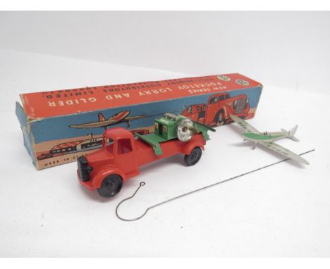 A boxed Wells-Brimtoy clockwork Pocketoy Lorry and Glider - red plastic cab and chassis with litho-printed tinplate winding a