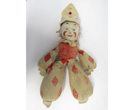 A  careworn 1930s Merrythought clown, moulded cloth face with painted features, harlequin print body with felt hands and feet