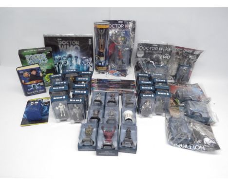 A collection of Doctor Who toys and collectables including boxed Eaglemoss figurines, Sonic Screwdriver, books, calendar etc.