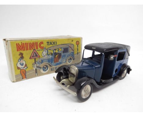 A boxed Triang Minic clockwork tinplate 35M Taxi Cab in dark blue and black, possibly repainted, missing one headlamp