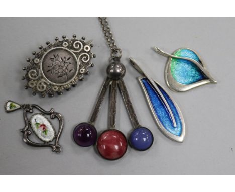 A Charles Horner pendant, two other silver and enamel pendants, a Scottish silver brooch and one other