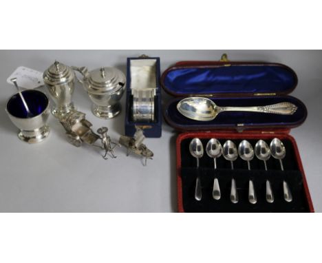 A George VI three piece silver condiment set, a cased set of six coffee spoons, a cased christening spoon, a cased napkin rin