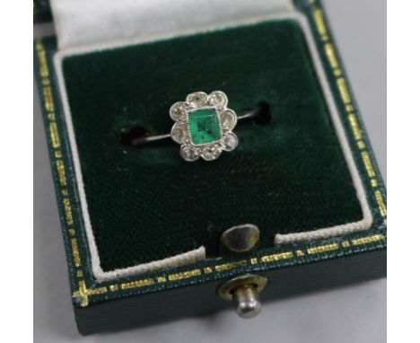 An 18ct gold diamond and emerald cluster ring, size L