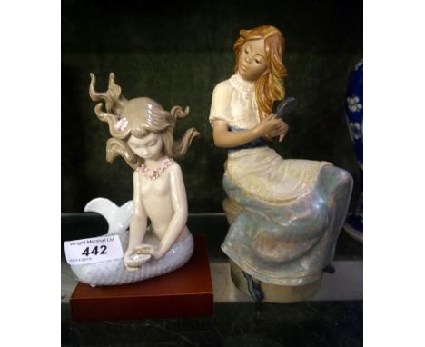 A Lladro model of a mermaid holding a oyster, together with a Nao Lladro model of a girl brushing her hair (2).