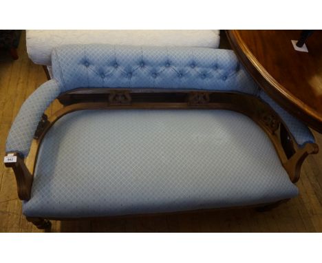 An Edwardian show wood framed sofa, upholstered in a blue material.