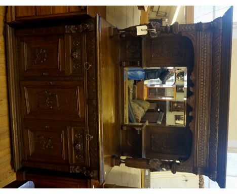 A good quality late 19th Century Dutch mirror back sideboard, the bevelled edge mirror plate flanked by two carved figures pl