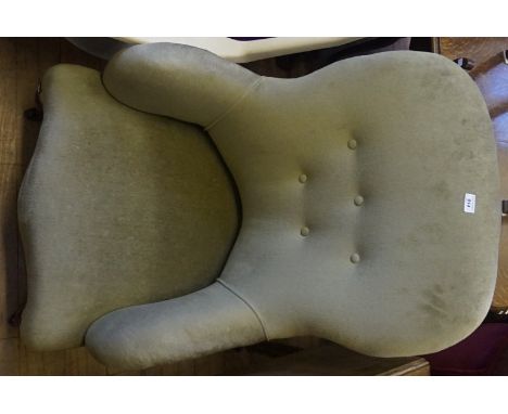A Victorian ladies spoonback armchair upholstered in a green button back material.
