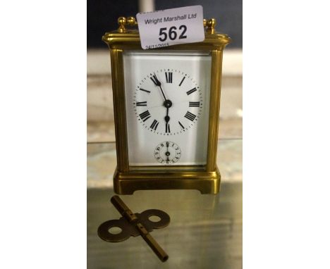 An early 20th Century French brass bound carriage clock with enamel dial.
