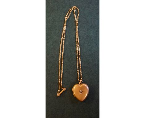 An Edwardian Chester hallmarked 9ct yellow gold heart shaped pendant locket, hinged to enclose photographs, set with a single