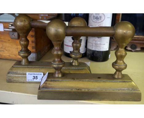A pair of vintage brass dog irons.