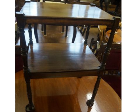 A 19th Century two tier mahogany whatnot terminating on ceramic castors.