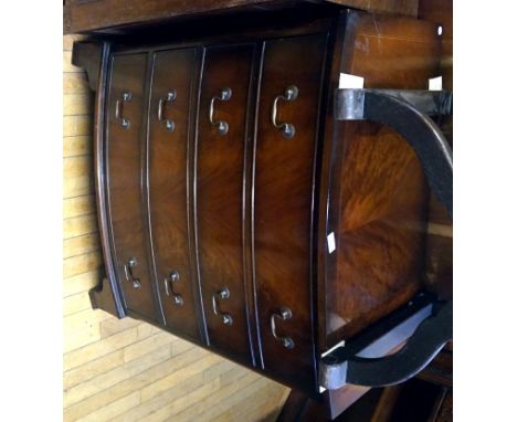 A reproduction mahogany bow front chest of four drawers, raised on bracket supports.  
