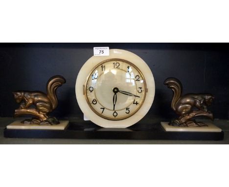An Art Deco style mantle clock of rectangular form, with central circular dial flanked by two spelter squirrels, length 54cm.