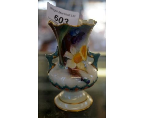 A Hadleys, Royal Worcester twin handled trumpet form vase with pinched rim and hand painted floral decoration.