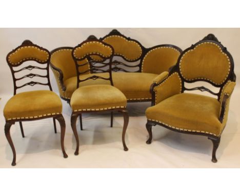 An Edwardian carved mahogany show wood framed four piece salon suite comprising an elegant sofa, approx 148cm wide, an armcha