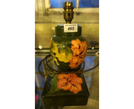 A Moorcroft 'Hibiscus' pattern ovoid form lamp together with a further Moorcroft 'Hibiscus' pattern lidded rectangular trinke