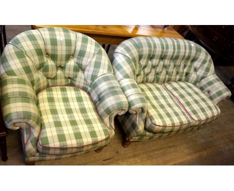 A modern two piece suite comprising two seater sofa and matching armchair, upholstered in a green tartan material.