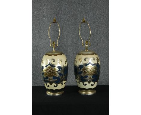 A pair of 20th century Japanese ceramic lamps with stylised metallic floral design on a cream ground. H.74cm. (each) 